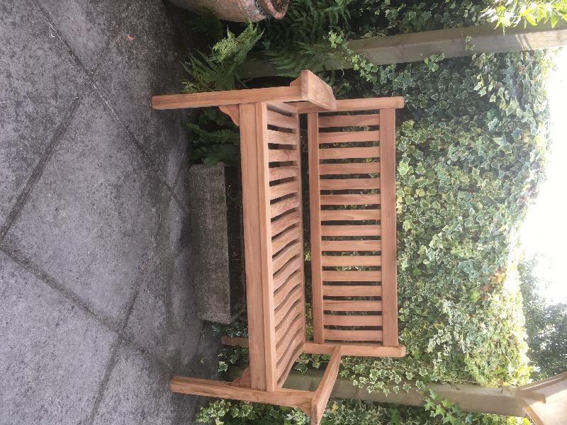 The bench moulded into the garden setting