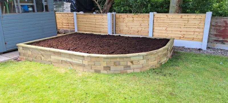 Raised bed designed to fit corner area